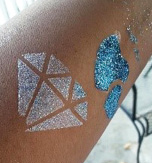 close up photo of glitter tattoo in the shape of a diamond and hearts