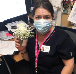 Riverhaven Nursing and Rehab Female Staff member with a small bouquet of flowers