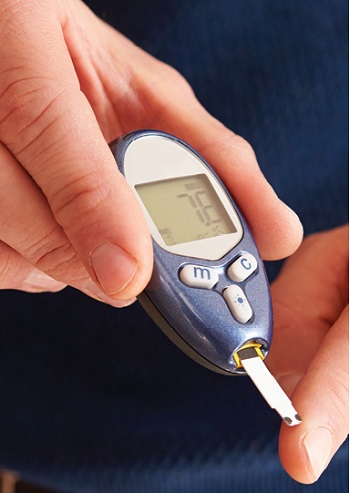 close up of man checking his blood sugar with glucometer