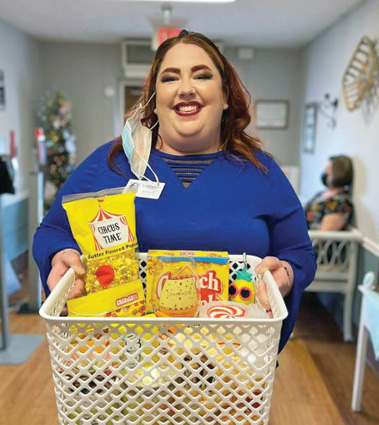 River Haven Social Worker Cassie pictured with a large basket of goodies