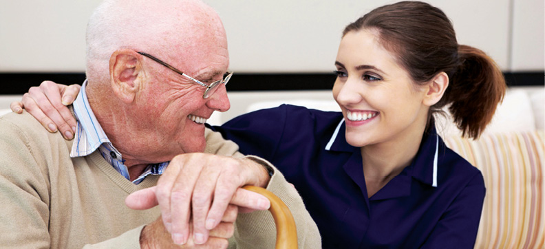 senior man sitting with female clinical health professional