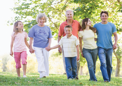 extended family walking in park holding hands