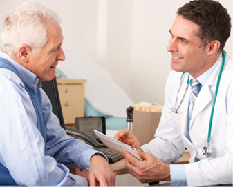 male doctor talking with senior man in doc office
